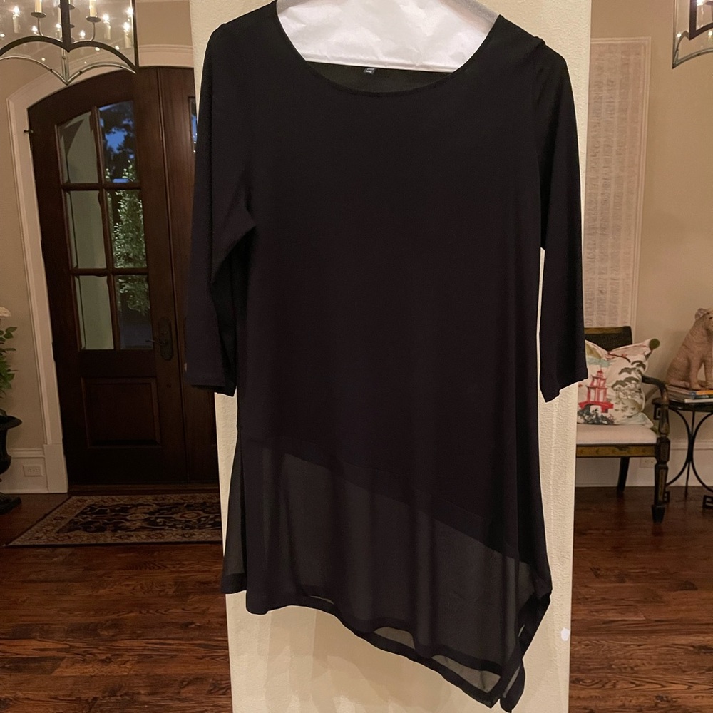 Elegant black knit blouse with sheer bottom.